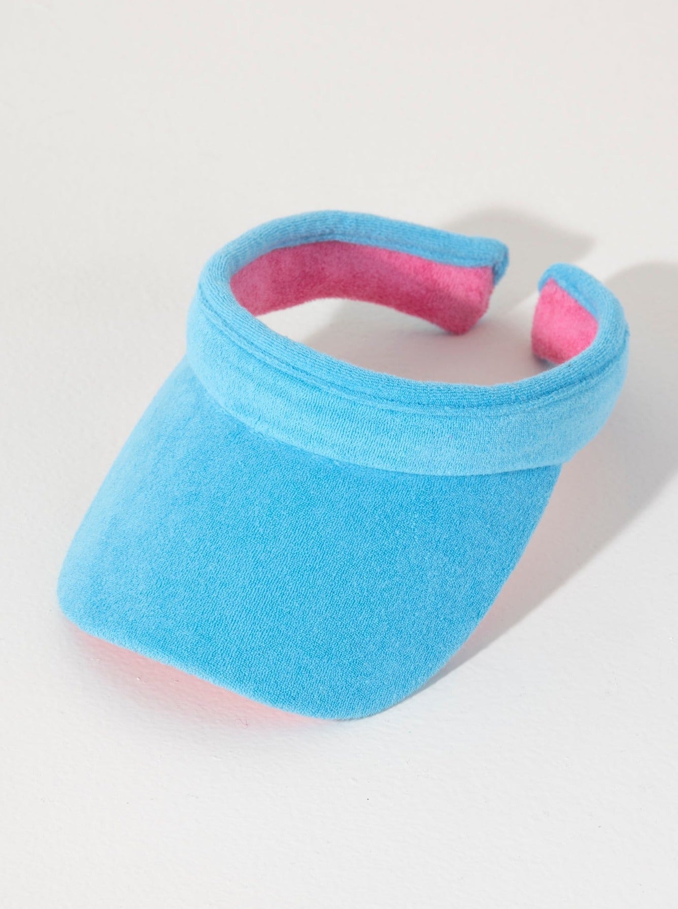 Keep your face shaded and dry this summer with Shiraleah's Sol Visor. Made from soft and absorbent cotton terry, this practical accessory is the perfect poolside companion. Its bright turquoise color matches the rest of Shiraleah's Sol collection. Pair with other items from Shiraleah's Poolside collection to complete your look!