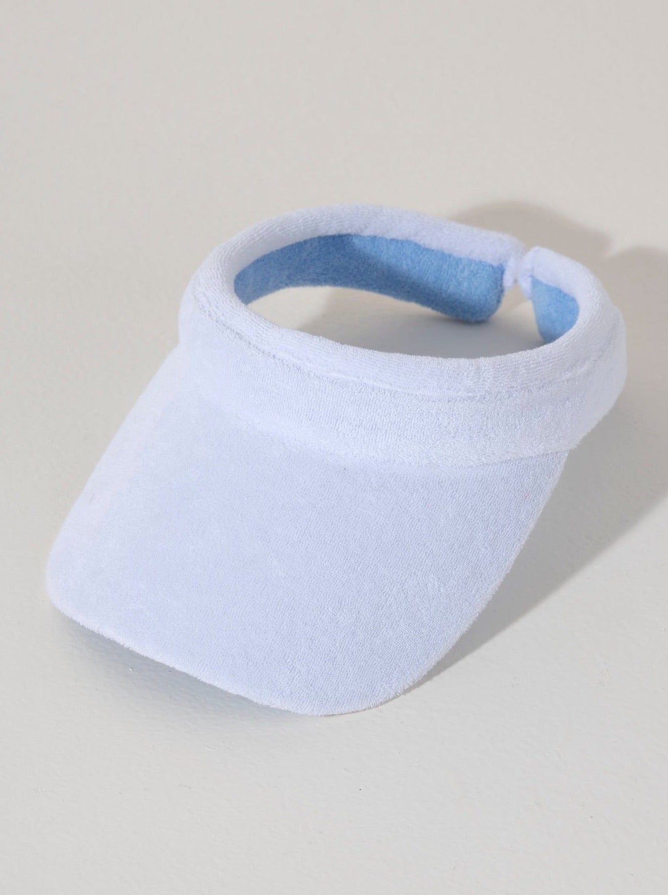 Keep your face shaded and dry this summer with Shiraleah's Sol Visor. Made from soft and absorbent cotton terry, this practical accessory is the perfect poolside companion. Its crisp white color matches the rest of Shiraleah's Sol collection. Pair with other items from Shiraleah's Poolside collection to complete your look!